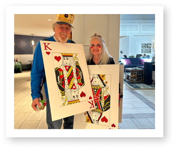 Elderly Couple Enjoying Themed Card Game Event in Assisted Living
