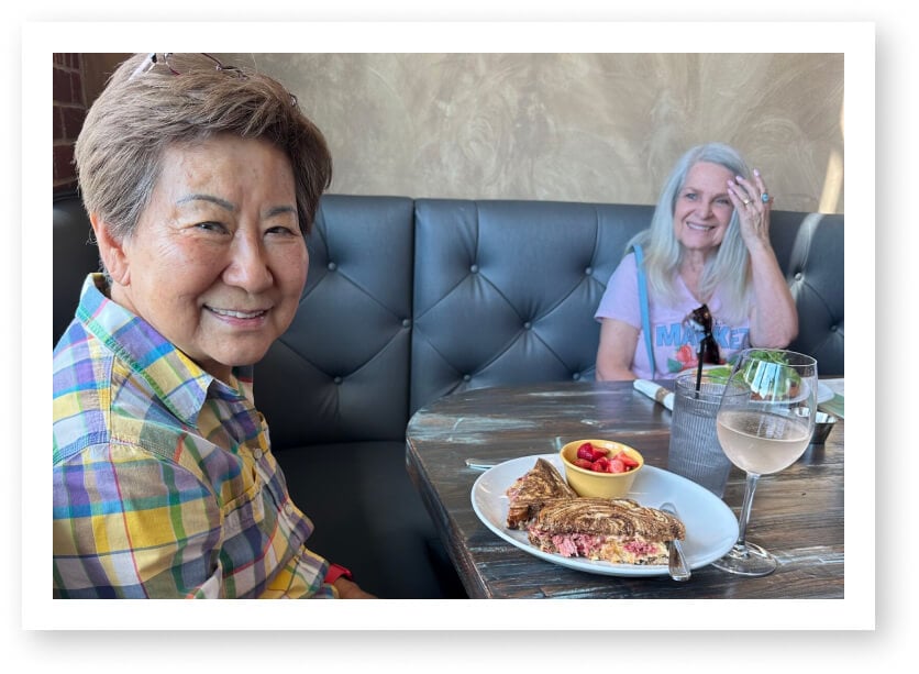 Residents Sharing Delicious Meal at Community Dining in Assisted Living